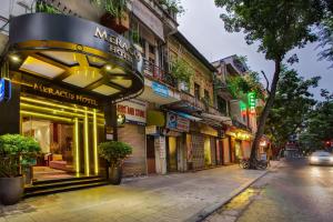 a street with a store on the side of a building at Mercury Central Hotel Hanoi in Hanoi
