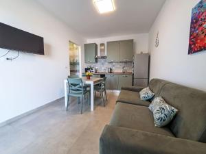 a living room with a couch and a table and a kitchen at Apartment Sogno di Emanuel by Interhome in Marzamemi