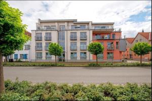 an apartment building with trees in front of it at FeWo "Hafenblick" in Barth