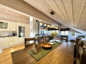 a kitchen and living room with a table and chairs at Cozy Ski-In Ski-Out Apartment on Geilo, Stunning Views! in Geilo