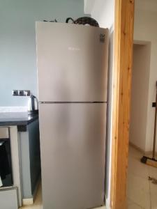 a white refrigerator in a kitchen next to a counter at Spacieux Appartement in Marrakech