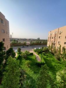 a view of a street in a city with buildings at Spacieux Appartement in Marrakech