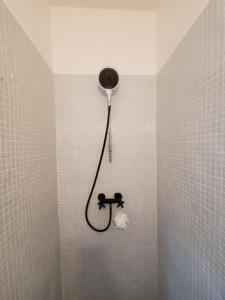 a shower in a tiled bathroom with a shower head at Spacieux Appartement in Marrakech +15 photos