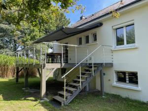 a house with a staircase next to a house at Maison de famille 5 ch idéale pour des réunions de familles in Sainte-Luce-sur-Loire