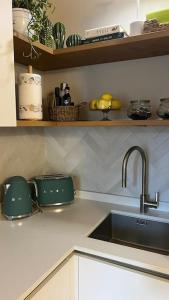a kitchen with a sink and a counter top with a sink at La casa di Gio in Lezzeno