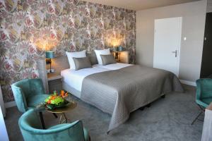 Postel nebo postele na pokoji v ubytování Van der Valk Hotel Avifauna