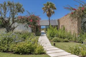 a garden with stairs leading to a building at Exclusive Luxury Villa with Stunning Sea Views in Cala Comte