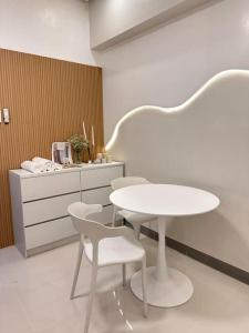 a white table and chairs in a room at Haiya's Staycation Aesthetic & Cozy in Tagaytay in Biluso +5 photos