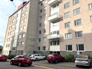 a group of cars parked in front of a building at Scandinavian apartments Heart of the city Kamppi 1, 5, 6 in Helsinki