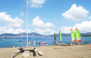 a group of sailboats on a beach with people on it at Lovely Home In Peri With Wifi in Peri
