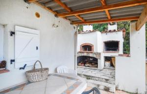 a patio with a fireplace and a table and chairs at Lovely Home In Peri With Wifi in Peri +8 photos