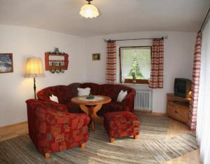 a living room with a couch and a table at Haus Auzinger in Schönau am Königssee