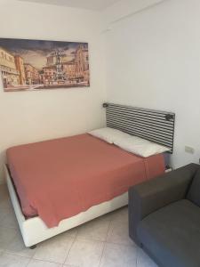 a small bedroom with a bed and a couch at STOP&GO STATION BOLOGNA HOUSE Self Check-In 24-24 Central City-Fiera in Bologna