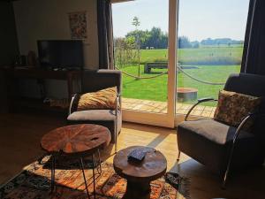 a living room with a view of a large window at Bed and Breakfast Op het Broek in Harfsen