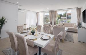 a dining room with a white table and chairs at Nice Home In Vrvari With Wifi in Poreč