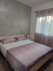 Ένα ή περισσότερα κρεβάτια σε δωμάτιο στο Apartman Kiara