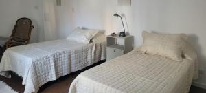 a bedroom with two beds and a lamp at Departamento en junin in Junín