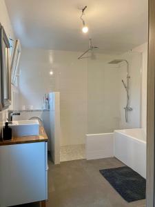 a bathroom with a shower and a tub and a sink at Maison de famille 5 ch idéale pour des réunions de familles in Sainte-Luce-sur-Loire