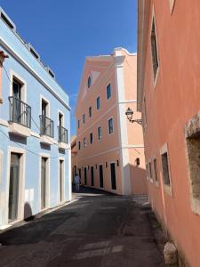 an empty street in an alley between two buildings at Belem em Azul in Lisbon