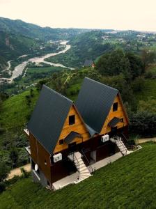 a house with a metal roof on top of a hill at Seyr-i Keyf Suit Bungalov in Rize