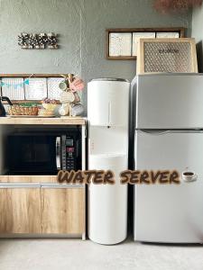 a kitchen with two refrigerators and a microwave at JaM in Noboribetsu
