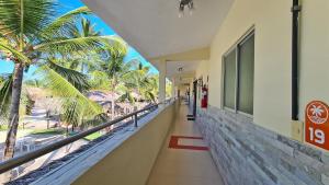a hallway of a building with a view of the beach at Arena Carneiros Hotel by AFT in Tamandaré
