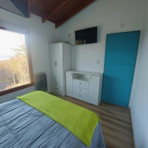 Postel nebo postele na pokoji v ubytování Cálida casa en el fin del mundo