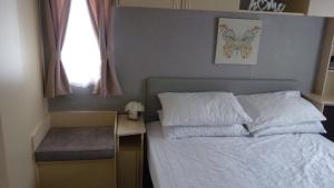 ein Schlafzimmer mit Bett, Schreibtisch und Fenster in der Unterkunft L&g FAMILY HOLIDAYS 6 BERTH CORAL BEACH LAURA FAMILYS ONLY AND LEAD PERSON MUST BE OVER 30 in Ingoldmells