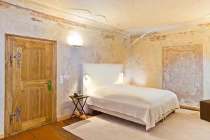 a bedroom with a bed and an open door at Hotel David an der Donau in Regensburg