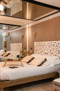 a bedroom with two beds with white sheets at Love Room 1001 nuits & Balnéo in Saint-Rambert-dʼAlbon +11 photos