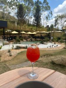 a drink in a glass sitting on a wooden table at Villaggio Zamprogno in Santa Teresa