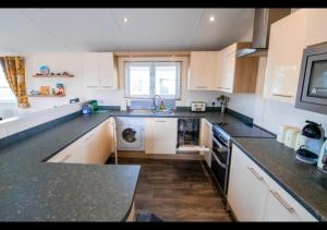 a kitchen with a sink and a dishwasher at MP629 Parkdean Camber Sands in Camber