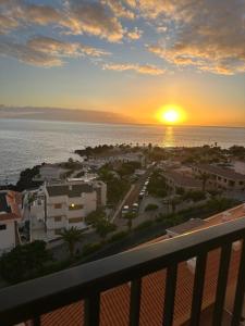 a sunset from the balcony of a condo at DORADO ATARDECER Beach Sand in Puerto de Santiago