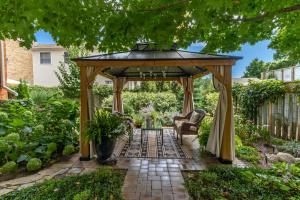 a gazebo in the middle of a garden at The 1885 Suites in Picton