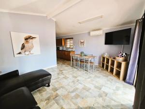 a living room with a couch and a television at Kilcoy Motel in Kilcoy