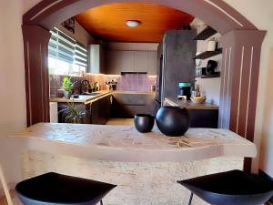 a kitchen with a counter with two bowls on it at Spasmata Village deluxe house only adults in Minia