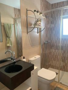 a bathroom with a sink and a toilet and a mirror at Apartamento 2 habitaciones ZEN in Deltebre