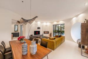 a living room with a couch and a table at 5br Golf & Pool Villa in Caparica | By Airnest in Aroeira