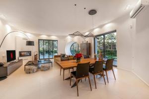a dining room and living room with a table and chairs at 5br Golf & Pool Villa in Caparica | By Airnest in Aroeira +51 photos