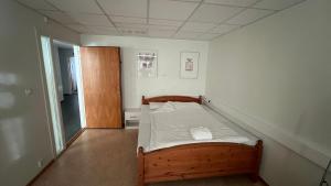 a small bedroom with a wooden bed in it at Sea side stay in Sand in Åsen