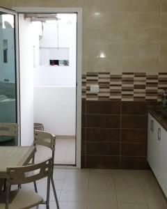 a kitchen with a table and chairs and a door at EZZAYATINE in Tunis +21 photos