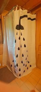 a shower curtain with a shark on it in a room at Appartement - dans le chalet Carmazin in Morgins +17 photos