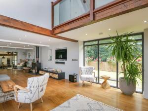 an open living room with a large glass wall at The Ivy Barn in Abergavenny