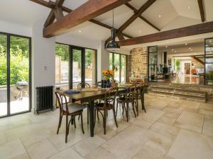 a dining room with a wooden table and chairs at The Ivy Barn in Abergavenny