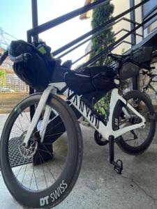 a bike is parked next to a fence at Sky Hostel in Peje