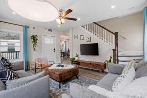 a living room with a couch and a tv at Beautifully Renovated 6BR 2BA 2 Blocks to Beach in Atlantic City