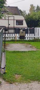 a trailer is parked next to a white fence at Øya husrom 2 in Sarpsborg