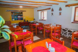 a dining room with wooden tables and chairs at Casa de Ollanta ByB in Ollantaytambo