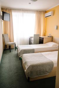 Posteľ alebo postele v izbe v ubytovaní 7 Days Hotel Kamyanets-Podilskyi