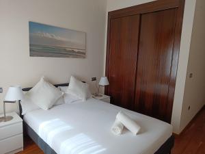 A bed or beds in a room at Apartamentos Palacio de los Jerónimos